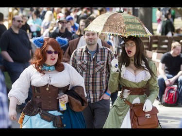 Katherine Lingwood (L) and Cali Kyhn walk the grounds as steampunk a Cheshire Cat and Mad Hatter during the Calgary Comic and Entertainment Expo at Stampede Park in Calgary, Alta., on Sunday, May 1, 2016. Lyle Aspinall/Postmedia Network