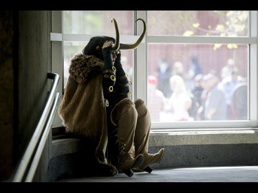 A cosplayer sits on a window ledge during the Calgary Comic and Entertainment Expo at Stampede Park in Calgary, Alta., on Sunday, May 1, 2016. Lyle Aspinall/Postmedia Network