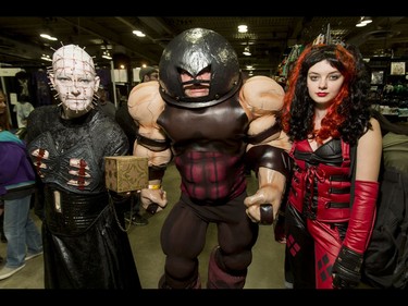 The Panasiuk family of mom Sarah (L), as Hellraiser Pinhead; dad Rene, as Juggernaut; and daughter Shelby, as Harley Quinn, strikes a pose during the Calgary Comic and Entertainment Expo at Stampede Park in Calgary, Alta., on Saturday, April 30, 2016. Lyle Aspinall/Postmedia Network