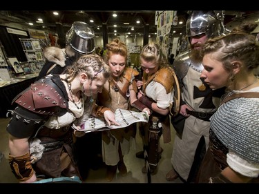 The Fenner siblings, first names (L-R) Rebekah, Jarvis, Alisha, Tara, Alex and Katie look through a program for their next stop during the Calgary Comic and Entertainment Expo at Stampede Park in Calgary, Alta., on Saturday, April 30, 2016. Lyle Aspinall/Postmedia Network