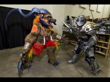 Richard Bowden (L), wearing Ifrit from Final Fantasy 10, prepares for battle with Ben Gibson, wearing Mordekaiser from League of Legends, during the Calgary Comic and Entertainment Expo at Stampede Park in Calgary, Alta., on Saturday, April 30, 2016. Lyle Aspinall/Postmedia Network