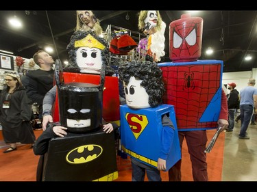 The Lego superhero family of mom Kayla Powell, dad Rob Penner and boys Rain Penner (L) and Loewen Powell mug for a photo during the Calgary Comic and Entertainment Expo at Stampede Park in Calgary, Alta., on Saturday, April 30, 2016. Lyle Aspinall/Postmedia Network