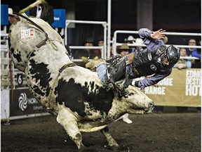 Jared Parsonage takes part in the bull riding event during the 42nd Canadian Finals Rodeo at Rexall Place in Edmonton, Alta., on Saturday, Nov. 14, 2015. Codie McLachlan/Edmonton Sun/Postmedia Network