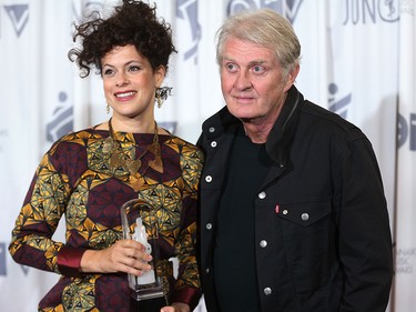 Regine Chassagne poses with Tom Cochrane after accepting the Allan Waters humanitarian award for Arcade Fire during the 2016 JUNO Gala Dinner & Awards in Calgary, Alta., on Saturday, April 2, 2016.