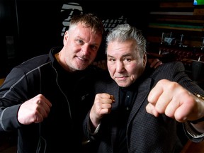 Former Canadian heavyweight boxer George Chuvalo (R) mugs for a photo with StopBully.com support services director Olaf Petersen inside Peanuts Pub in the Carriage House Inn in Calgary.