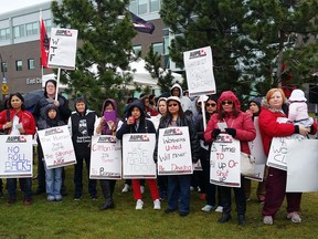 Staff of Clifton Manor, a seniors home run by the Brenda Strafford Foundation, and their supporters stand outside Clifton Manor in southeast Calgary on Monday, April 25, during a rally organized by the Alberta Union for Provincial Employees to protest proposed rollbacks to overtime pay, starting wages and benefits, as well as a proposed salary freeze, in a bargaining process with the Brenda Strafford Foundation that has been dragging on for more than one year. (Alia Dharssi/Postmedia)