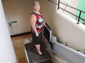 Luanne Whitmarsh, CEO of the Kerby Centre, shows a handicap lift at the 55-plus facility.