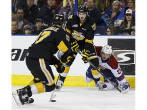 Edmonton's Lane Bauer (right) battles Brandon's Mitch Wheaton (right) and John Quenneville during the second period of a WHL playoff game between the Edmonton Oil Kings and the Brandon Wheat Kings in Edmonton, Alta., on Wednesday March 30, 2016. Photo by Ian Kucerak