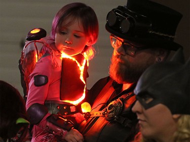Lava Girl aka Olivia Stroud, 4, warms up her dad Shane backstage before the kids costume showcase at the Calgary Comic and Entertainment Expo in the Stampede Corral on Saturday, April 30, 2016.