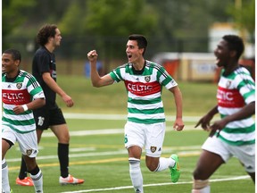 Aryn Toombs/Calgary Herald CALGARY, AB -- June 21, 2015 -- Foothills FC players Darius Ramsay, left, Dominick Zator and Elijah Adekugbe celebrate scoring over the Washington Crossfire at Hellard Field in Calgary on Sunday, June 21, 2015. (Aryn Toombs/Calgary Herald) (For SPORTS story by TBA) 00066270A SLUG: 0621 Foothills FC vs. Washington