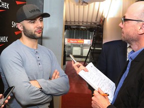 Calgary Flames captain Mark Giordano talks to Calgary Herald sports columnist Scott Cruikshank at the Scotiabank Saddledome as the team cleared out their lockers for the season on Monday, April 11, 2016.
