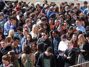 Thousands of job hunters wait to get into the Big Four Building at the Stampede Grounds for the annual youth job fair in Calgary in April 2016.