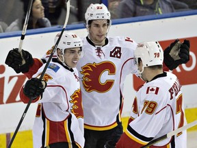 Calgary Flames' Johnny Gaudreau (13), Sean Monahan (23) and Micheal Ferland (79) celebrate a goal against the Edmonton Oilers during third period NHL action in Edmonton, Alta., on Saturday, April 2, 2016.