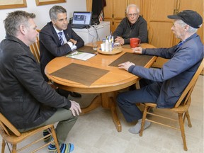 Human Services Minister Irfan Sabir , centre, and Ryan Geake, executive director of Calgary scope society, left, visits with Loyd Thornhill, foreground, and Harold Gregory in a group home at 26 Hallmark Place SW in Calgary, AB., on Friday, April 1, 2016.