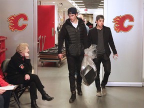 Calgary Flames Sean Monahan and Johnny Gaudreau walk out of the Scotiabank Saddledome as the team cleared out their lockers for the season on Monday, April 11, 2016.