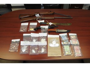 Mounties seized drugs, weapons and nearly $1,000 in cash while executing a search warrant at a home on 26th Street and 4th Avenue in Fort Macleod on April 22, 2016.