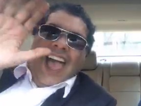 Mayor Naheed Nenshi waves at the camera in a Boston ride-sharing vehicle in this image from a Periscope video.