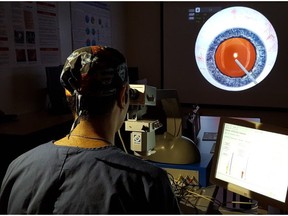 Dr. Vikram Lekhi, resident, uses the EYESI surgical simulator.