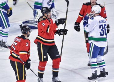 The Calgary Flames forward Joe Colborne, centre left, celebrate after scoring against the Vancouver Canucks during hockey action at the Scotiabank Saddledome in Calgary, AB., on Thursday, April 7, 2016. The Flames lead the NHL regular season gamegame 5-3 after the second period. (Photo by Andy Maxwell Mawji/ Postmedia)