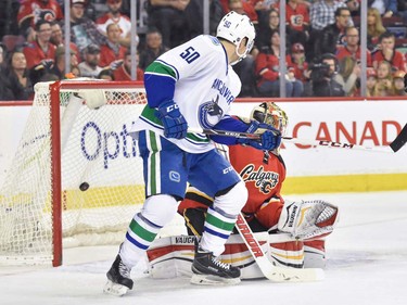 The Vancouver Canucks score their second goal during hockey action against the Calgary Flames at the Scotiabank Saddledome in Calgary, AB., on Thursday, April 7, 2016. The teams were tied 2-2 at the end of the first period. (Photo by Andy Maxwell Mawji/ Postmedia)