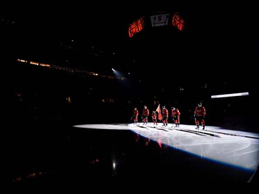 The Calgary Flames starting line stands together before a game against the Vancouver Canucks during hockey action at the Scotiabank Saddledome in Calgary, AB., on Thursday, April 7, 2016. The two teams were tied 2-2 at the end of the second period. (Photo by Andy Maxwell Mawji/ Postmedia)