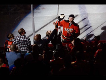 The Calgary Flames forward Matt Stajan gives his stick to a fan after winning against the Vancouver Canucks during hockey action at the Scotiabank Saddledome in Calgary, AB., on Thursday, April 7, 2016.. The Flames won the NHL regular season game 7-3.(Photo by Andy Maxwell Mawji/ Postmedia)