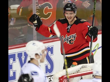 Calgary Flames Mikael Backlund celebrates with teammates after scoring against the Vancouver Canucks during NHL hockey in Calgary, Alta., on Thursday, April 7, 2016. AL CHAREST/POSTMEDIA