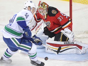 Calgary Flames goalie Joni Ortio stones Brendan Gaunce of the Vancouver Canucks on a breakaway during the first period at the Saddledome Thursday night April 7, 2016.  (Ted Rhodes/Postmedia)