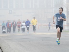 Brent Griffin runs through a foggy course at the Calgary Police Half Marathon at Mount Royal University in Calgary, Alta., on Sunday, April 24, 2016.