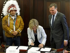(Left to right) Deputy Grand Chief Isaac Laboucan-Avirom, Premier Rachel Notley and Indigenous Relations Minister Richard Feehan sign a protocol agreement between the Government of Alberta and Treaty 8 First Nations at the Alberta Legislature on Tuesday April 26, 2016.