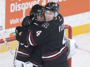 Rebels Haydn Fleury hugs goalie Trevor Martin to celebrate the win overy the Hitmen during Western Hockey League playoff action between the Red Deer Rebels and the Calgary Hitmen at the Stampede Corral in Calgary, Alta on Friday April 1, 2016. Jim Wells//Postmedia