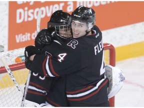 Rebels Haydn Fleury hugs goalie Trevor Martin to celebrate the win overy the Hitmen during Western Hockey League playoff action between the Red Deer Rebels and the Calgary Hitmen at the Stampede Corral in Calgary, Alta on Friday April 1, 2016. Jim Wells//Postmedia