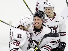 REBELS VS. HITMEN--Red Deer Rebels goaltender Trevor Martin gets a hug from Adam Helewka as the Rebels celebrate following their Game 5 and series win over the Calgary Hitmen at the Enmax Centrium in Red Deer, Alta. Saturday night. Photo by ASHLI BARRETT/Red Deer Advocate