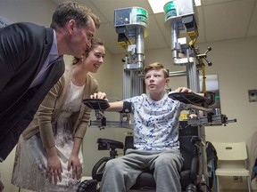 Max Challoner, 12, demonstrates the KINARM robotic device at the Foothills Medical Centre in Calgary on Monday, April 4, 2016. Researchers Andrea Kuczynski and Dr. Adam Kirton helped develop the device, which measures proprioception, the ability to know where your limbs are in space.