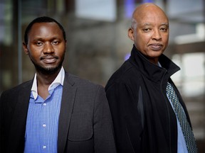 Andy Amour, right, of the local Rwandan community and Gabriel Mbonigaba, a genocide survivor, pose for a photo in Calgary on Wednesday, April 6, 2016.