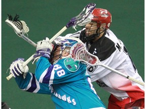 The Calgary Roughnecks' Mike Carnegie and Rochester Knighthawks' Cody Jamieson collide during National Lacrosse League action at the Scotiabank Saddledome in Calgary on Saturday March 5, 2016. Calgary lost 9-8 in overtime. (Gavin Young/Postmedia) (For Sports section story by TBA) Trax# 00072523A