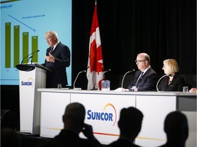 Steve Williams, left, president and CEO of Suncor Energy, addresses the company's crowded annual meeting in Calgary on Thursday.