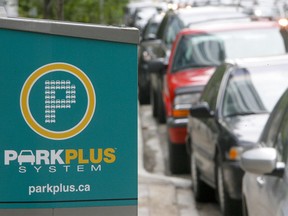 Cars park near a ParkPlus kiosk in downtown Calgary.