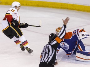 Calgary's Mikael Backlund (11) scores on Edmonton's goaltender Cam Talbot (33) during the third period of a NHL game between the Edmonton Oilers and the Calgary Flames at Rexall Place in Edmonton, Alta., on Saturday April 2, 2016. Photo by Ian Kucerak
