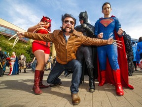 The Scarlet Witch (Jen Rey), Batman (Franz Miguel), Superman (Peter Fourlaris) and a snarling Wolverine (Dale Kliparchuk) at the annual Parade of Wonders that kicks off the Calgary Comic & Entertainment Expo at the BMO Centre in Calgary, Ab., on Friday April 29, 2016. Mike Drew/Postmedia