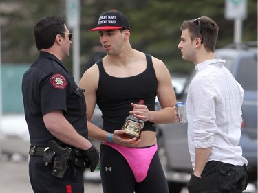 2012 - A police officer talks to students at a party associated with Bermuda Shorts Day across the street from the University of Calgary