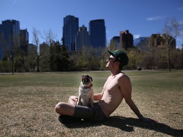Gabriel Thiel and his dog Lulu,7, enjoy the heat in Calgary on Tuesday, April 19, 2016.