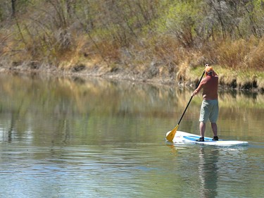 A paddler enjoys a peaceful day on the Elbow River as he enjoys warm temperatures in Calgary on Tuesday, April 19, 2016.