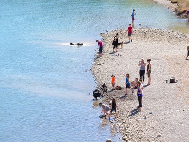 Weather revellers enjoy the Bow River at Edworthy Park in Calgary on Tuesday, April 19, 2016. The city was poised to a break a temperature record set in 1910 when 26.7 C was recorded.