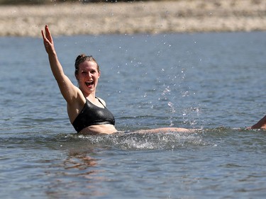 Leah Shevkenek splashes in the Bow River in Calgary on Tuesday, April 19, 2016. The city is poised to a break a temperature record set in 1910 when 26.7 C.