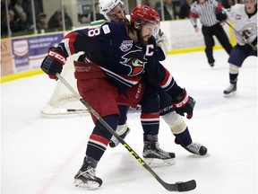 The Spruce Grove Saints' Macklin Pichonsky (2) battles the Brooks Bandits' Derek Lodermeier (18) during second period AJHL action at Grant Fuhr Arena, in Spruce Grove Alta. on Friday April 15, 2016. Photo by David Bloom