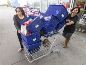 Rita Khanchet (L) and Saima Jamal push their purchase to the parking lot at the Rundle Superstore in Calgary, on Thursday, May 5, 2016.