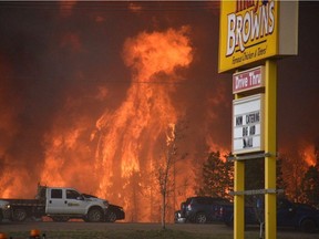 A wall of fire rages outside of Fort McMurray on May 3.