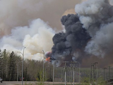 A wildfire rage through Fort McMurray Alta, on Wednesday May 4, 2016. The wildfire has already torched 1,600 structures in the evacuated oil hub of Fort McMurray and is poised to renew its attack in another day of scorching heat and strong winds. TTHE CANADIAN PRESS/Jason Franson ORG XMIT: EDM114