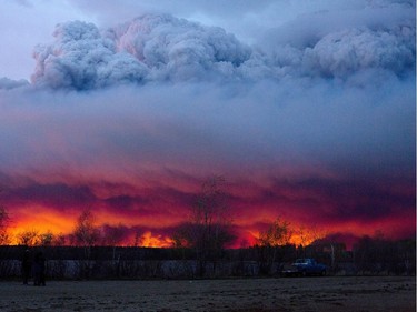 A wildfire moves towards the town of Anzac from Fort McMurray, Alberta., on Wednesday May 4, 2016. Alberta declared a state of emergency Wednesday as crews frantically held back wind-whipped wildfires. Unseasonably hot temperatures combined with dry conditions have transformed the boreal forest in much of Alberta into a tinder box.  (Jason Franson/The Canadian Press via AP) MANDATORY CREDIT ORG XMIT: EDM130
